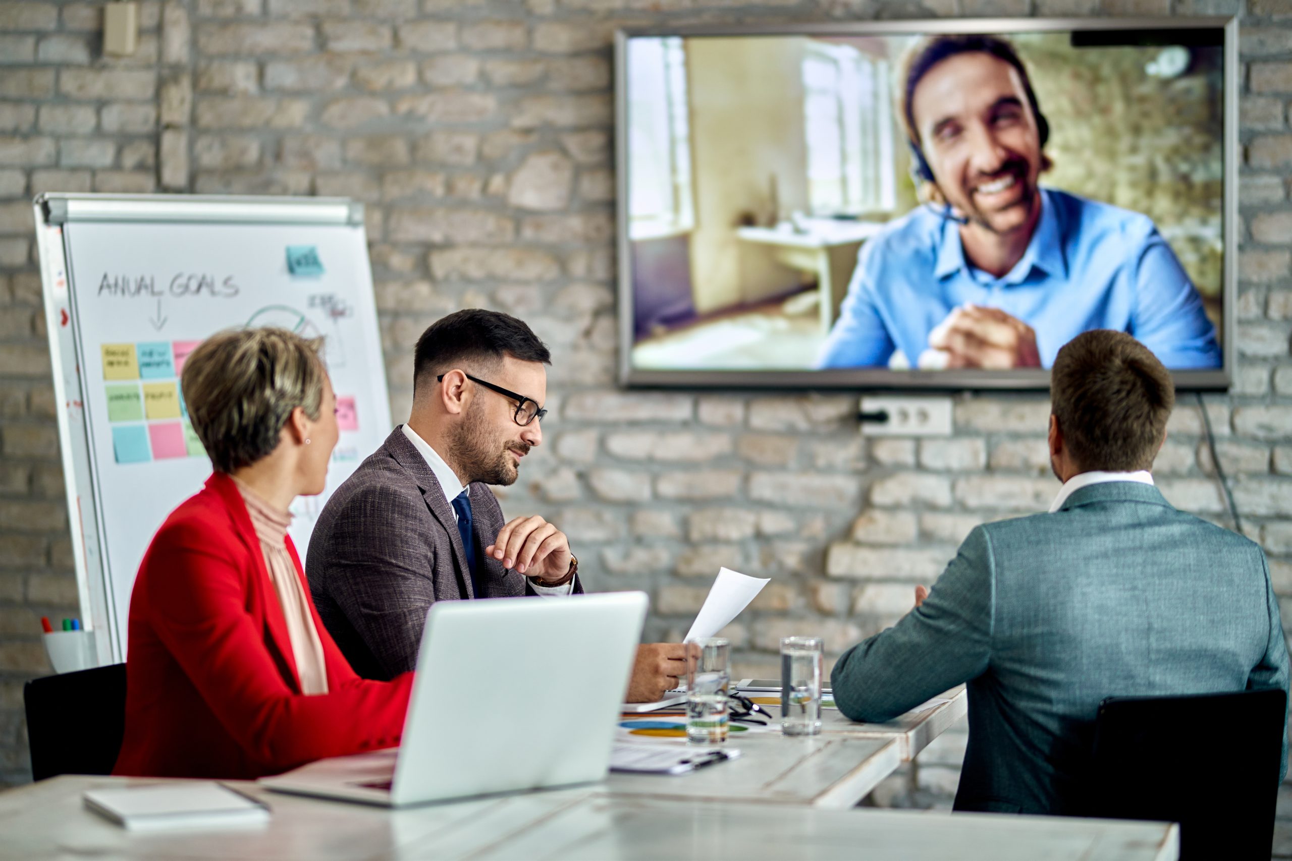 group entrepreneurs having business meeting communicating with their colleague via video call office scaled